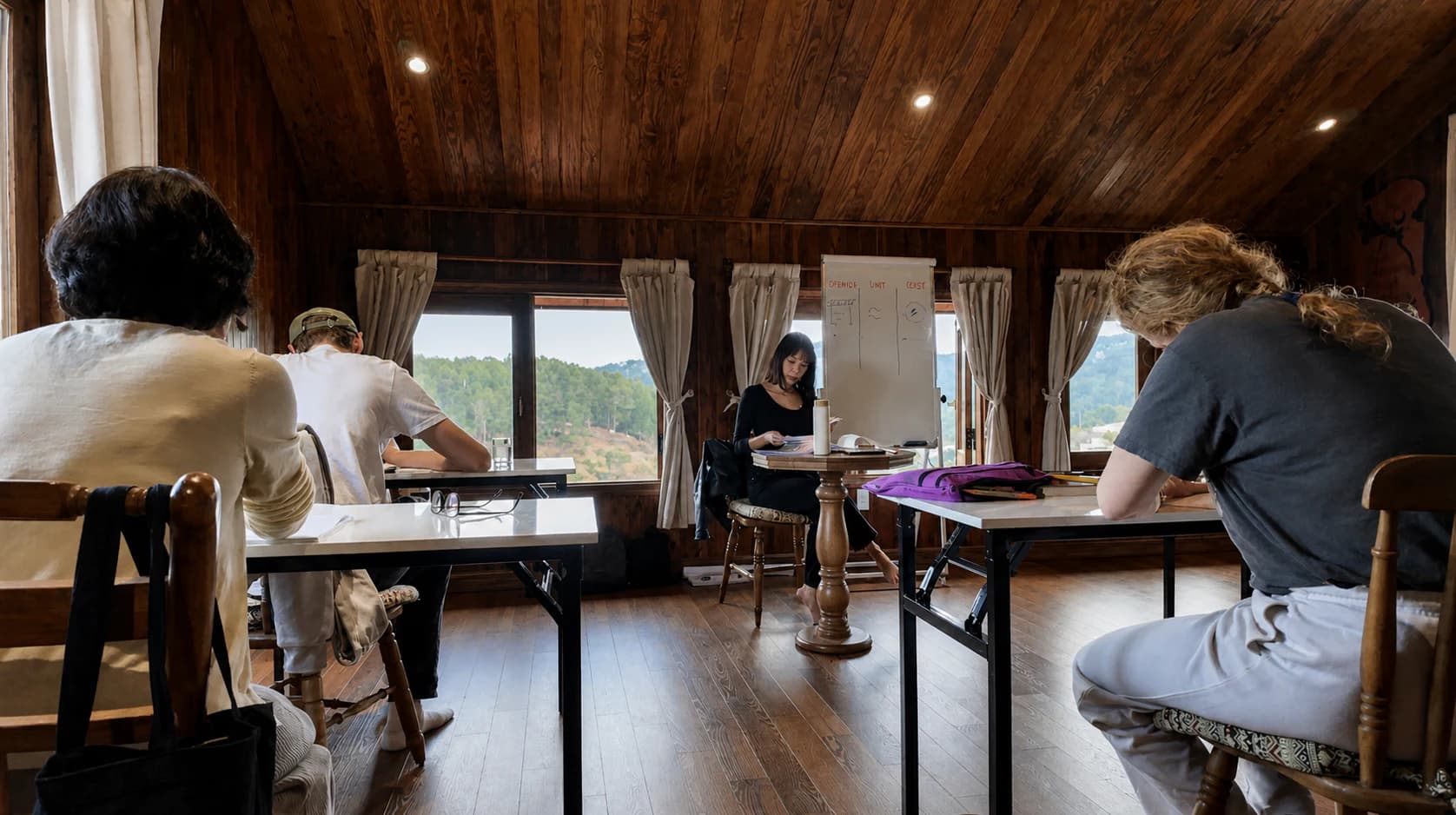Senior professionals working individually during a PaperFrame strategy session in Da Lat